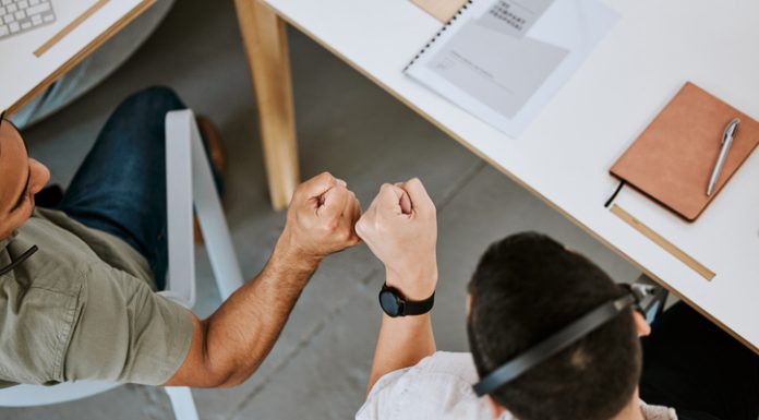 Leveraging Job Portals for Career Success Excited call centre agents, fist bump and celebrating deal, promotion and sale from above in office. Motivated, happy and successful telemarketing colleagues or customer support operators cheering