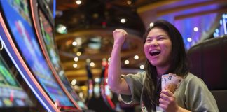 Unlocking the World of VIP Casino Experiences exited asia female woman slot machine gambling cheerful smile hand pressing bet button in casino club entertainment concept,exited asian woman hand play slot machine in casino hotel
