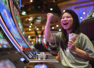 Unlocking the World of VIP Casino Experiences exited asia female woman slot machine gambling cheerful smile hand pressing bet button in casino club entertainment concept,exited asian woman hand play slot machine in casino hotel