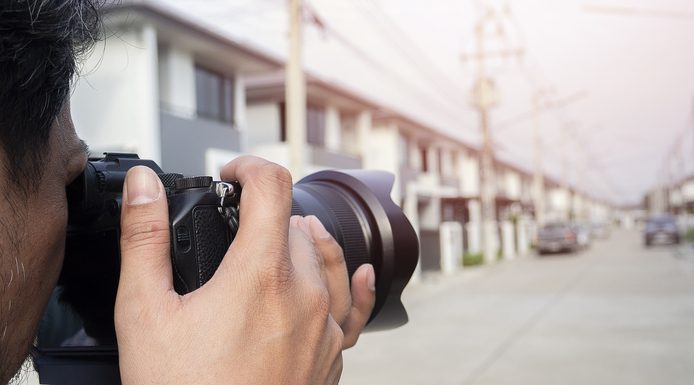 Boost Property Sales with a Real Estate Photographer Close up hands of Young Asian photographer taking pictures of housing estates.