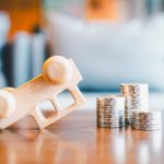 The Basics of Personal Injury Claims in Detroit An overturned car that was hit with coins stack. Concepts of a symbol for car insurance, vehicle car auto repair service maintenance.