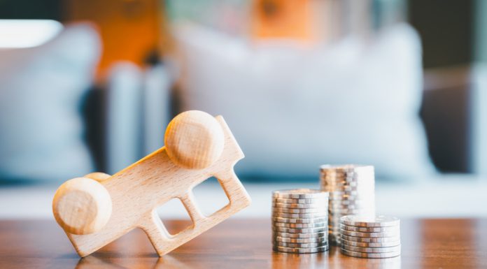 The Basics of Personal Injury Claims in Detroit An overturned car that was hit with coins stack. Concepts of a symbol for car insurance, vehicle car auto repair service maintenance.