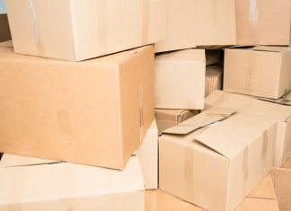 Moving for your Business Growth: Choose the Right Office Mover Detail of many cardboard boxes full of household items during a move.
