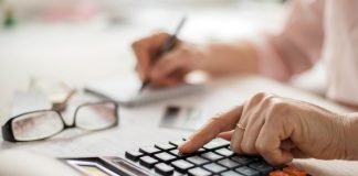 DiamondCapitals Offering Exclusive Benefit Program For Senior Clients Pension calculation concept, old hands counting finances on a home calculator , close- up