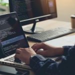 How Custom Web Development Companies Change the World of Finances? Professional Development programmer typing on a laptop Computer Keyboard. Screens Show Coding Language User Interface. Program Development, software, and coding technology, artificial chat, Website design.