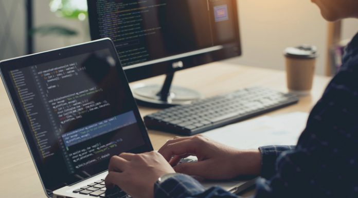Professional Development programmer typing on a laptop Computer Keyboard. Screens Show Coding Language User Interface. Program Development, software, and coding technology, artificial chat, Website design.