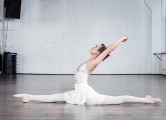 Slim graceful young woman doing the splits