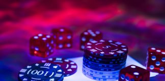 Expert Gambling Tips from the Pros Casino abstract photo. Poker game on red background. Theme of gambling.