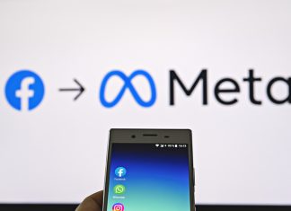 Meta’s Strategic Pivot: Mark Zuckerberg Bets on Private Messaging to Transform Business Interaction Mobile display with logo of Facebook, WhatsApp and Instagram apps in hand against blurred META logotype on white monitor