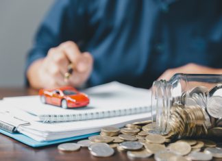 Concept of car insurance business, saving buy - sale with tax and loan for new car. Car toy vehicle with stack coin money on background. Planning to manage transportation finance costs. loan for car