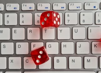 Unleash Entertainment at iasia88, No Limit – The Ultimate Online Game Hub Red dice lying on white keyboard as online casino concept