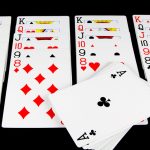 The Competitive Edge: Strategies for Winning at Online Solitaire Playing Cards Game on Black Background