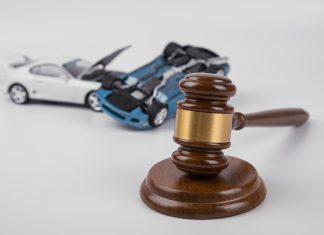 Collision and Consequences: Unraveling Car Accidents in the Courtroom hammer of the judge. two collided cars on a white background.