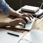 Attention Europe: eFormula is Changing the Online Business Game! Close up businessman using laptop, sitting at work desk