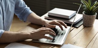 Attention Europe: eFormula is Changing the Online Business Game! Close up businessman using laptop, sitting at work desk