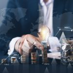 Businessman holding illuminated light bulb