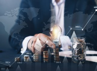 Businessman holding illuminated light bulb