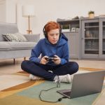 Tips to Keep Kids Preoccupied With Fun Online Games Red Haired Boy Playing Video Games on Floor