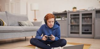 Tips to Keep Kids Preoccupied With Fun Online Games Red Haired Boy Playing Video Games on Floor