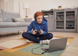 Red Haired Boy Playing Video Games on Floor
