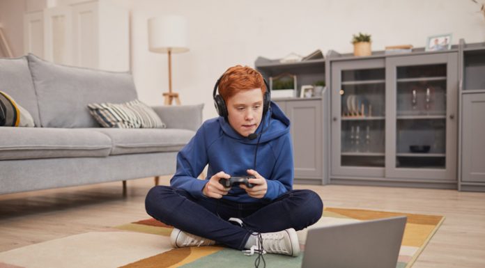 Red Haired Boy Playing Video Games on Floor
