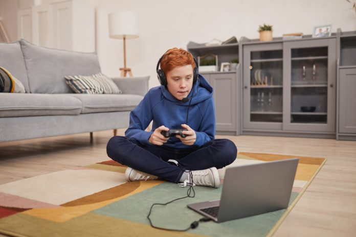 Red Haired Boy Playing Video Games on Floor