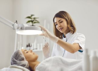 Female beautician holding injection