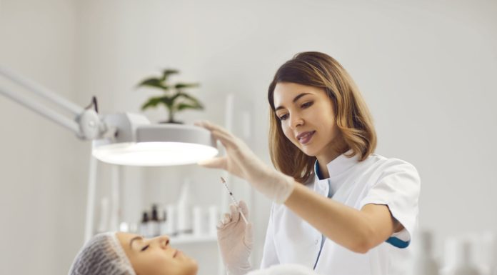 Female beautician holding injection