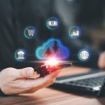 Navigating The World Of Personal Finance Apps: Simplifi And Its Competitors smartphone and a laptop computer with cloud computing diagram show on hand