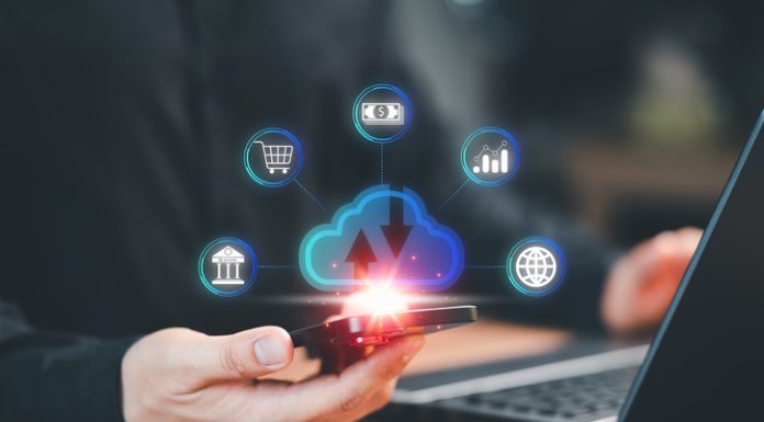 Navigating The World Of Personal Finance Apps: Simplifi And Its Competitors smartphone and a laptop computer with cloud computing diagram show on hand