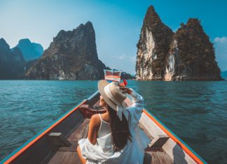 Tech-Powered Travel: 8 Must-Know Trends for Your Next Adventure Traveler asian woman relax and travel on Thai longtail boat in Ratchaprapha Dam at Khao Sok National Park Surat Thani Thailand