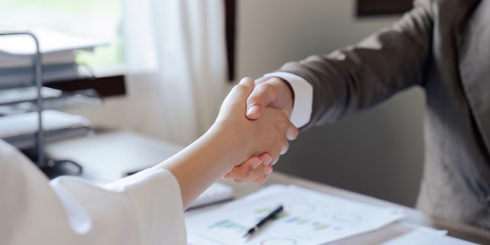 Closeup Handshake of businesspeople and a partner after planning strategy marketing in the office Negotiation