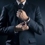 Businessman Fixing Cufflinks his Suit