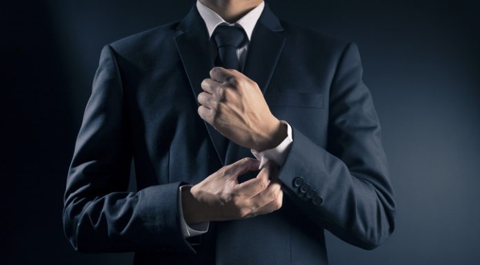 Businessman Fixing Cufflinks his Suit