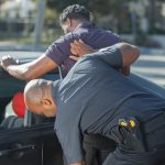 Explaining OVI in Ohio: Understanding the Offense and Its Consequences A man being searched by police officers