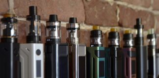 The Unique Challenges Facing Norway’s Vape Shops Electronic cigarette on a background of vape shop.
