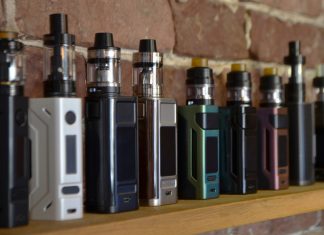 Electronic cigarette on a background of vape shop.
