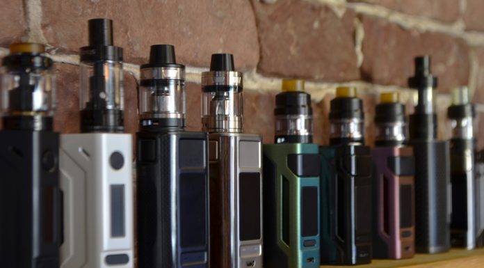 Electronic cigarette on a background of vape shop.