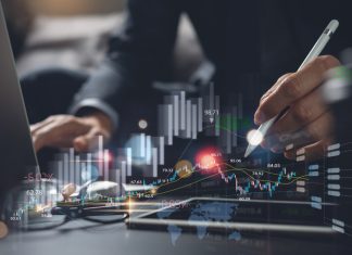 Businessman using digital tablet analyzing sales data and monitoring economic growth graph chart on virtual screen
