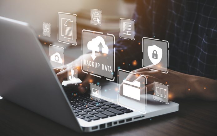 Businessman using a computer to backup storage data Internet technology concept for backup online documentation database and digital file storage system or software,file access, doc sharing. back up storage and photos