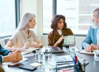Choosing the Right UX Design Agency: What Businesses Need to Know Tablet, meeting and business people in discussion in office planning creative project in collaboration.