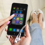 InstaGrowth Essentials: Unveiling the Best 4 Websites to Skyrocket Your Instagram Account Apple iPhone 7 in woman hand with icons of social media facebook, instagram, twitter, snapchat application on screen