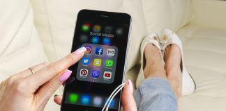 InstaGrowth Essentials: Unveiling the Best 4 Websites to Skyrocket Your Instagram Account Apple iPhone 7 in woman hand with icons of social media facebook, instagram, twitter, snapchat application on screen