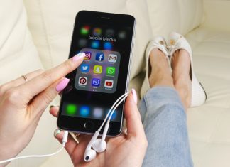 Apple iPhone 7 in woman hand with icons of social media facebook, instagram, twitter, snapchat application on screen