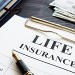 life insurance, pen and dollars