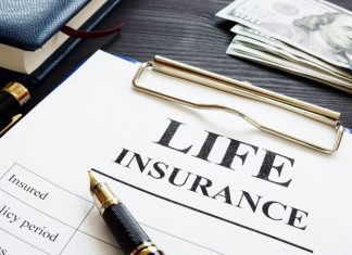 life insurance, pen and dollars