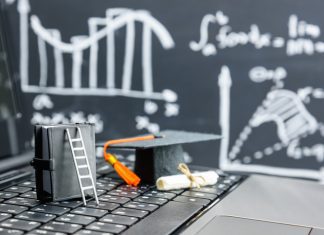 The Opportunities and Challenges of MBAs black graduation cap on computer keyboard