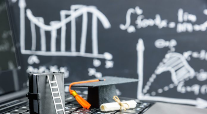 black graduation cap on computer keyboard