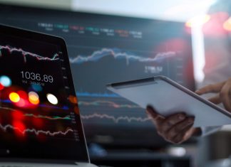 businessman using tablet on profit trading
