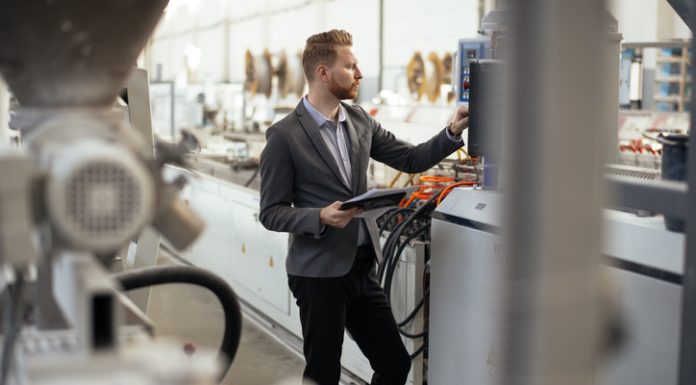 Achieving Cost Reduction in Manufacturing: Strategies and Tools Business man checking quality on laptop in factory